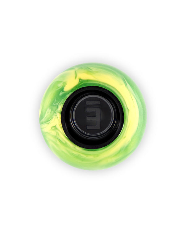 A circular fidget spinner with a marbled lime green and yellow outer ring and a black center featuring a stylized white '3' logo, shown on a solid white background.