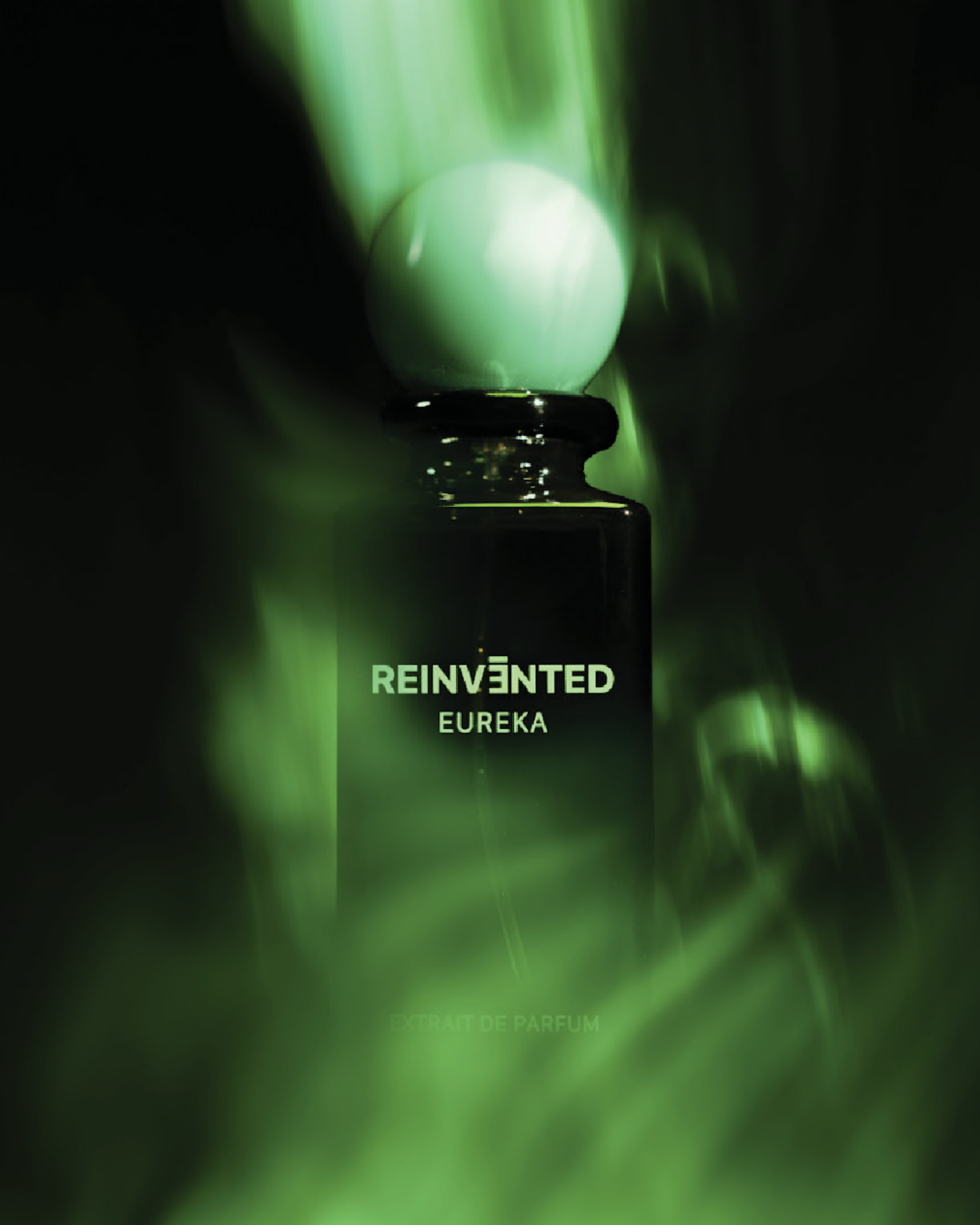 Image of Perfume bottle labeled 'REINVENTED Eureka' with green smoke effect on a dark background