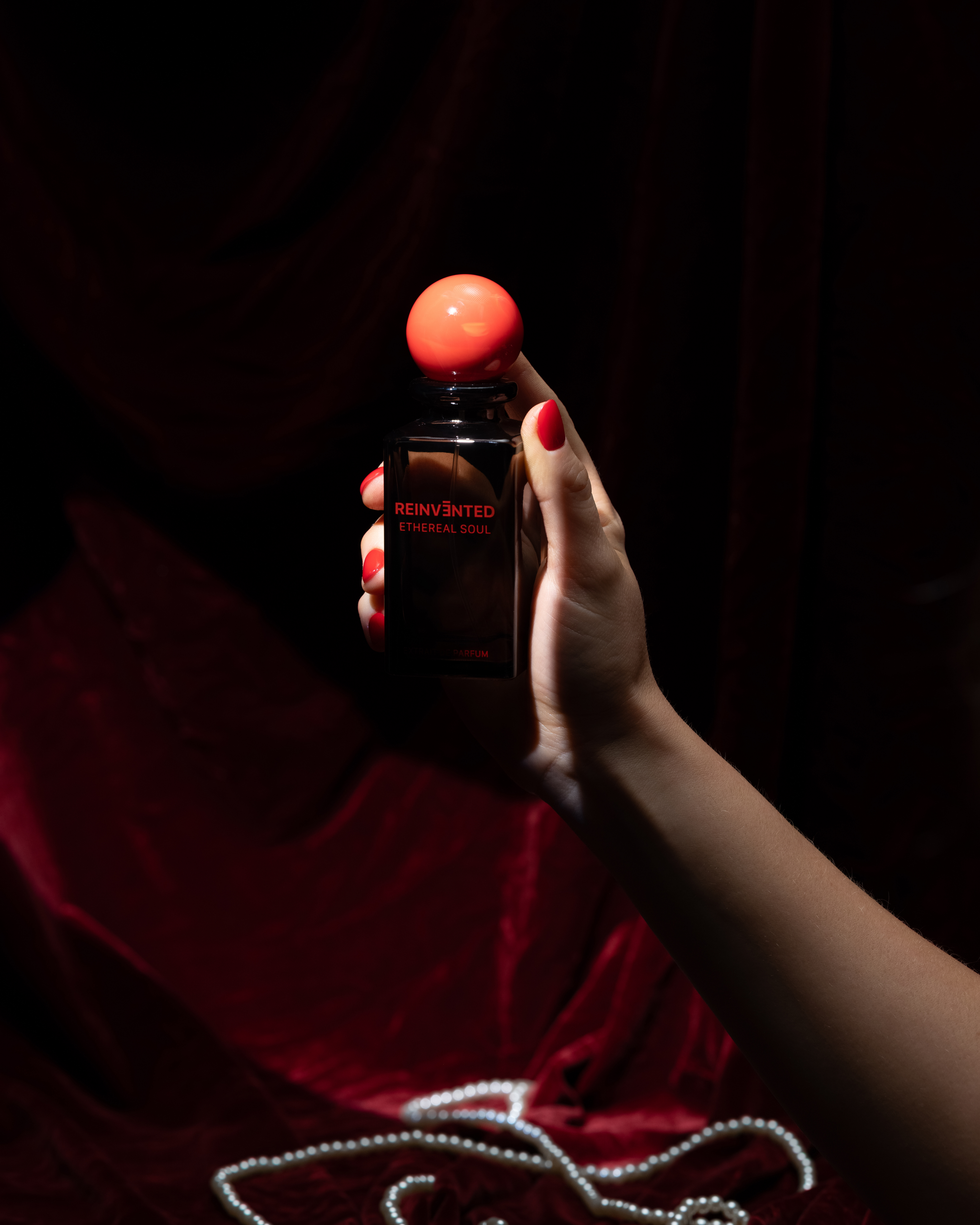 Image of Hand holding a bottle of Hennessy V.S.O.P. Cognac against a dark background