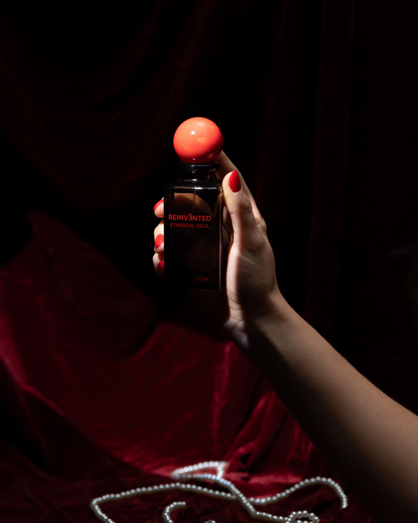 Hand holding a bottle of Hennessy V.S.O.P. Cognac against a dark background