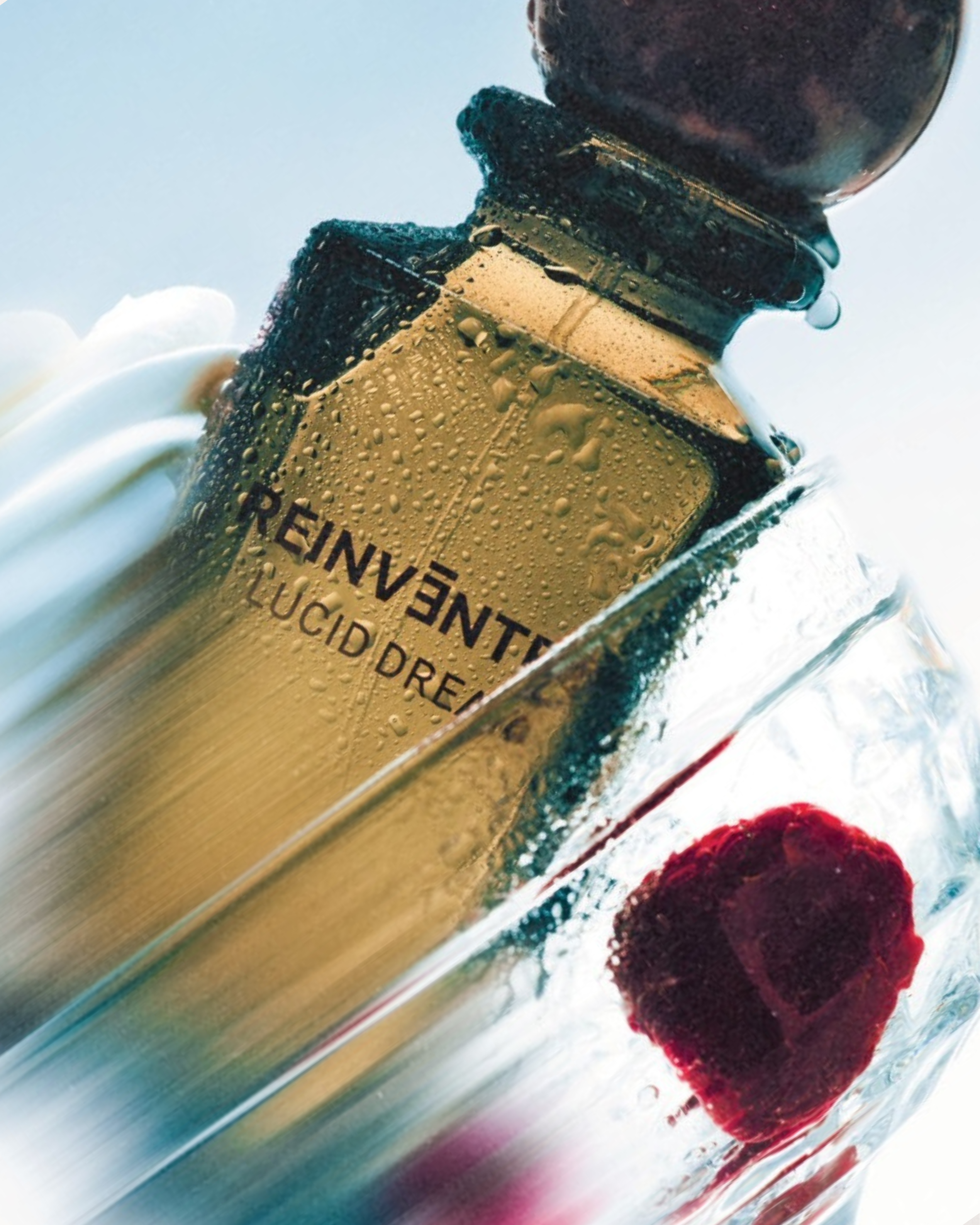 Image of Close-up of a perfume bottle with 'Reinvent' and 'Lucid Dream' text on a blurred background.