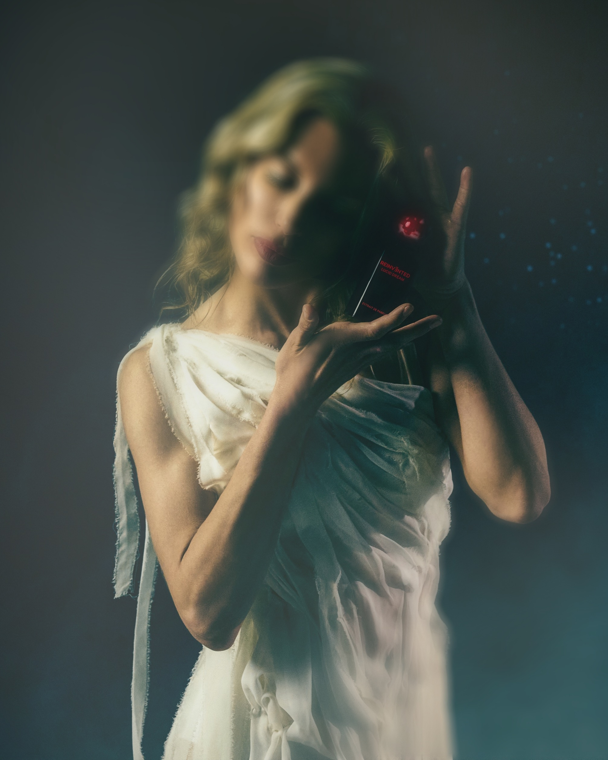 Image of Woman holding a vintage camera with a dark background